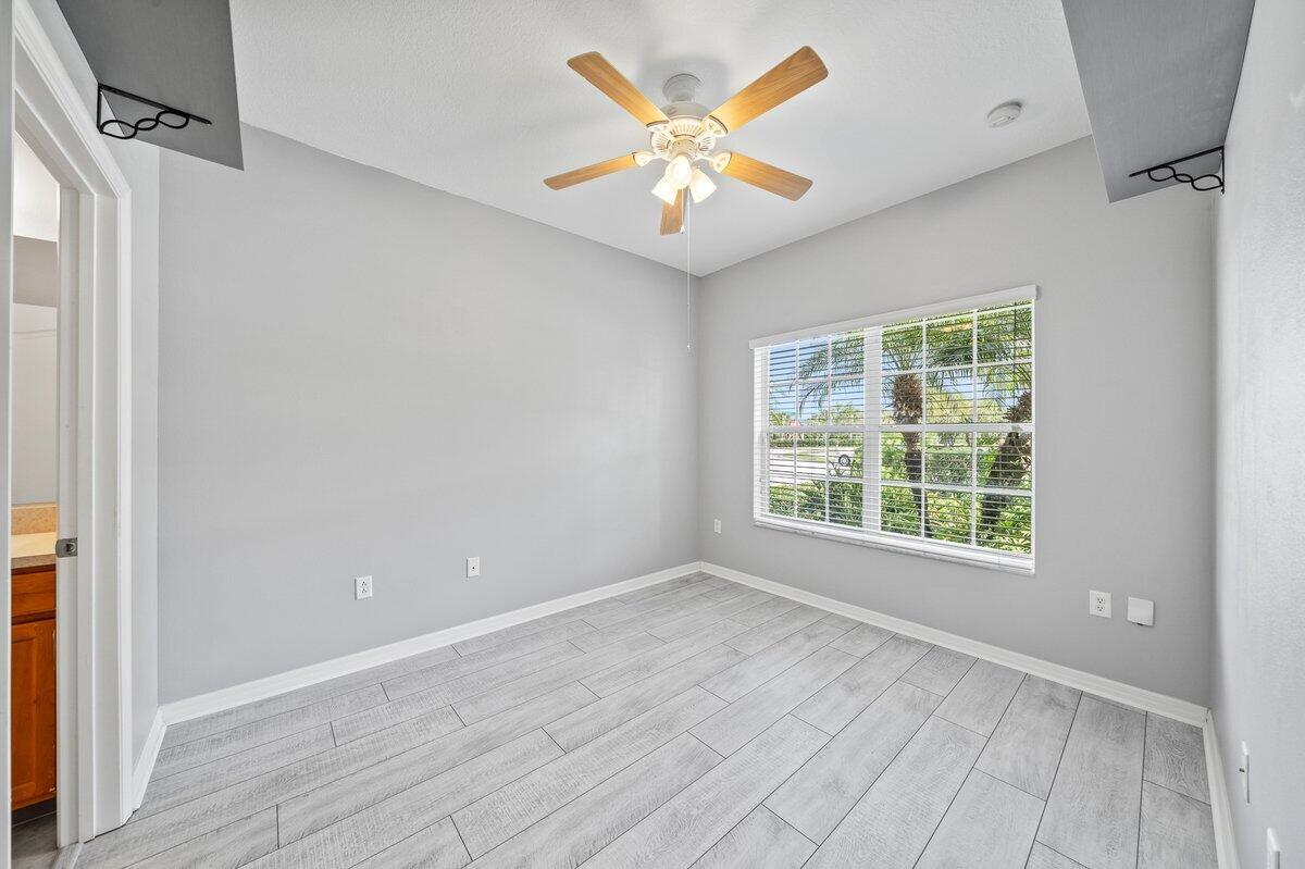 2980 Le Conte Street Melbourne, FL 32940 - Photo 13 of 25 an empty room with wooden floor and windows