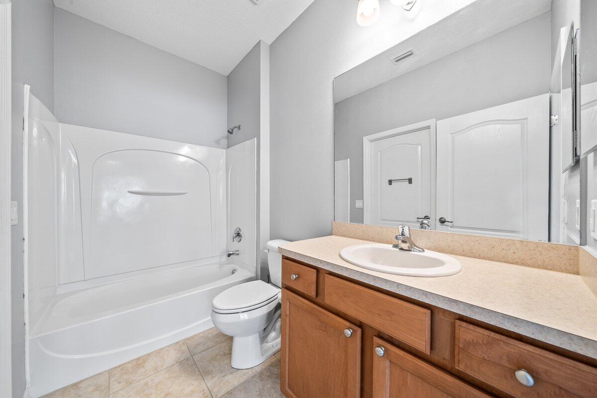 2980 Le Conte Street Melbourne, FL 32940 - Photo 15 of 25 a bathroom with a sink a toilet and shower