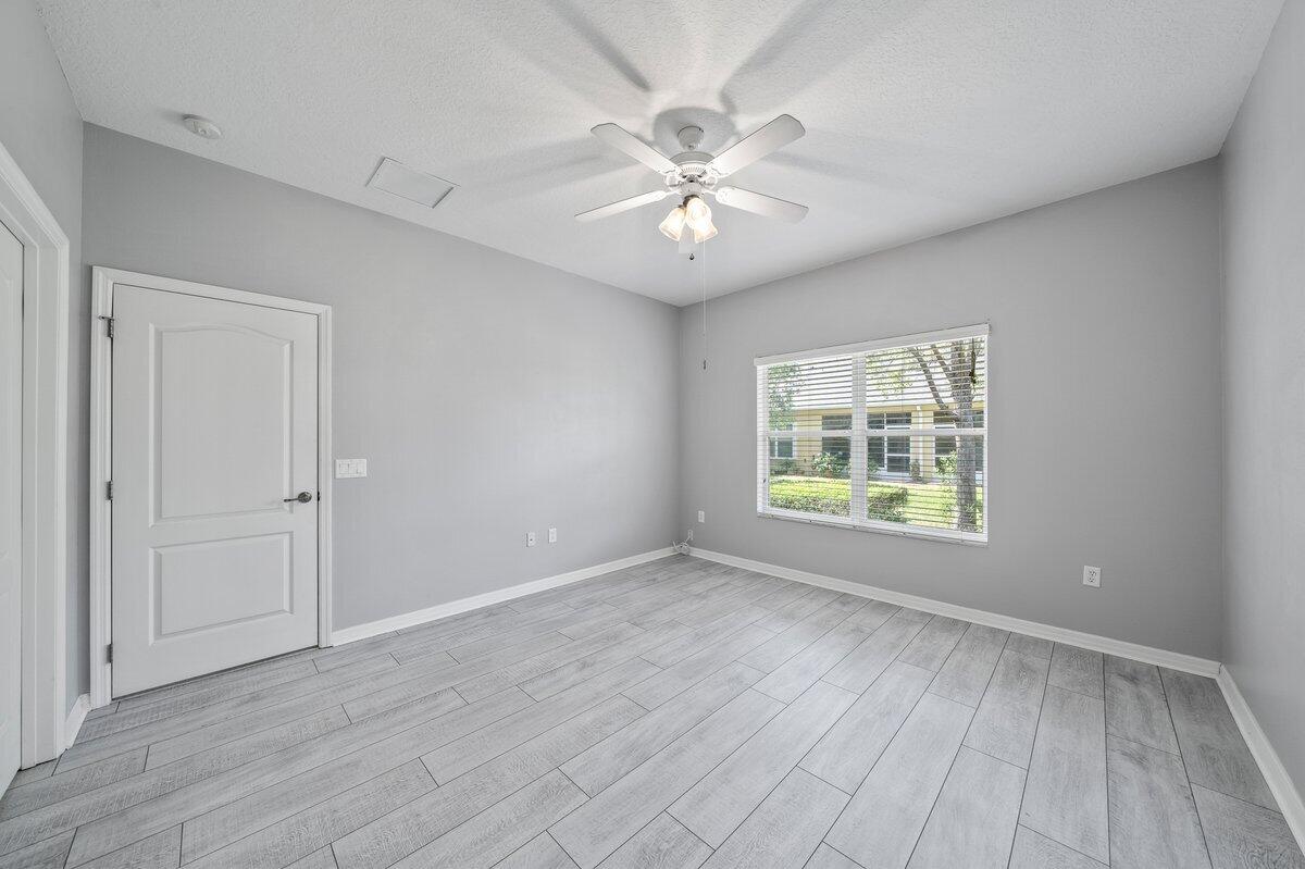 2980 Le Conte Street Melbourne, FL 32940 - Photo 17 of 25 a view of an empty room with wooden floor and a window