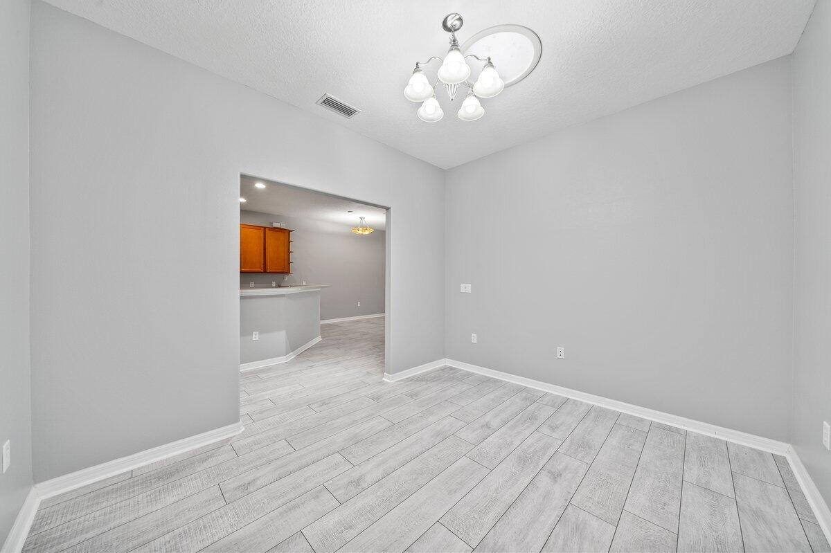 2980 Le Conte Street Melbourne, FL 32940 - Photo 6 of 25 wooden floor in an empty room with a window