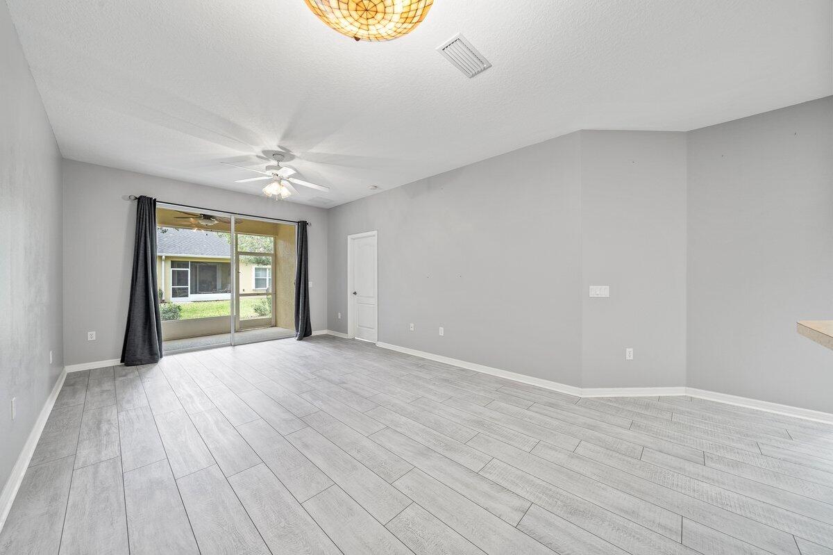2980 Le Conte Street Melbourne, FL 32940 - Photo 8 of 25 a view of an empty room with a window and wooden floor