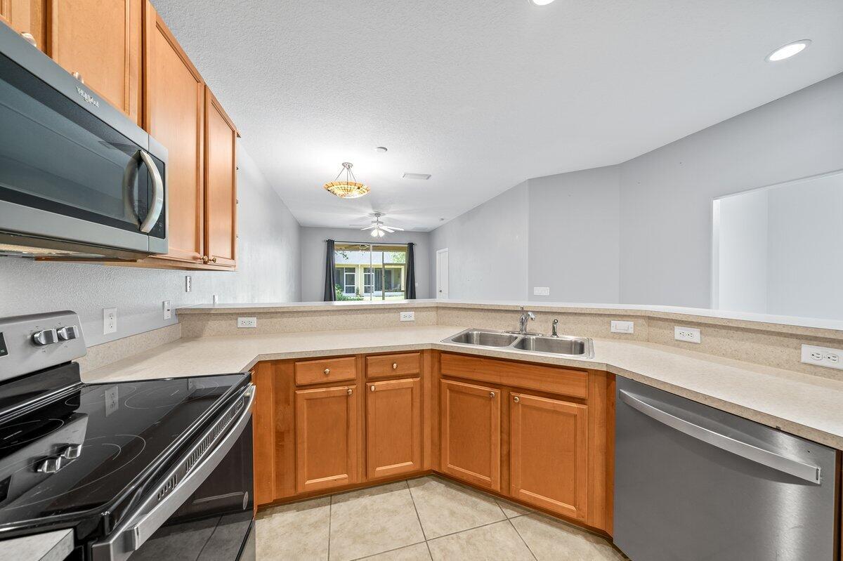 2980 Le Conte Street Melbourne, FL 32940 - Photo 10 of 25 a kitchen with a sink stove and microwave