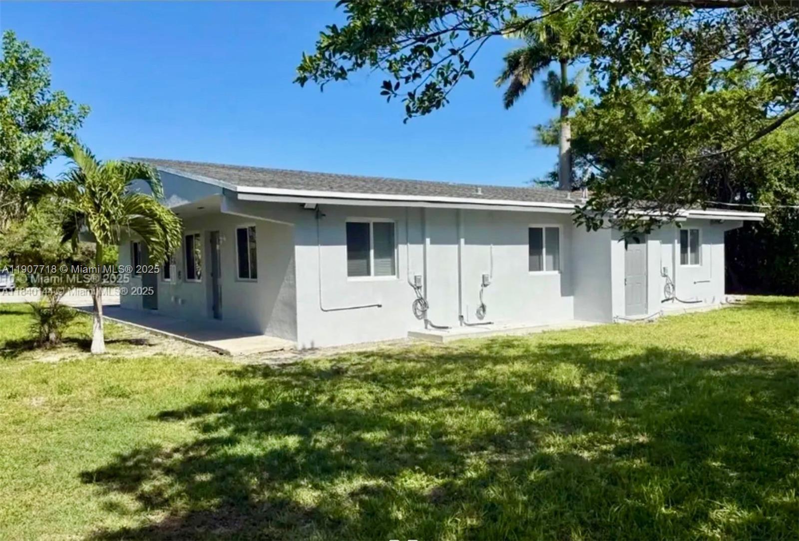 22210 Southwest 116th Avenue, Unit D Miami, FL 33170 - Photo 2 of 4 a backyard of a house with table and chairs