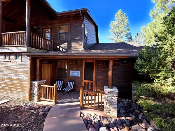 front view of a house with a bench