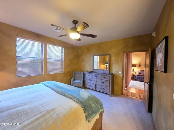 a spacious bathroom with a shower a sink and a mirror