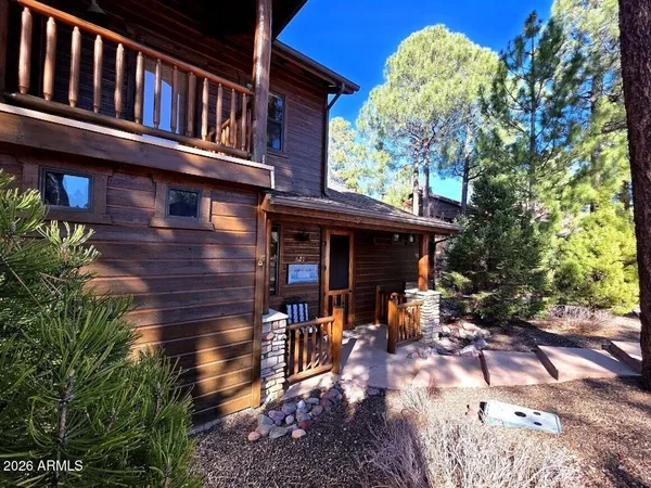 a view of a house with backyard porch and sitting area