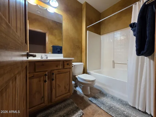 a spacious bedroom with a bed and a chandelier