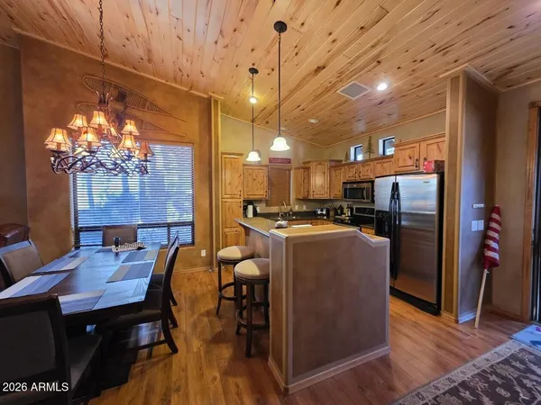 a dining room with furniture and a chandelier
