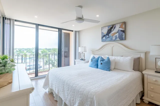 a bedroom with a large bed and a large window