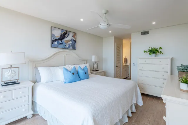 a bedroom with a bed and a painting on the wall