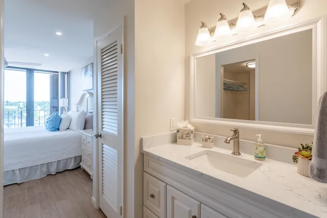 a en suite bathroom with a double vanity sink and a mirror