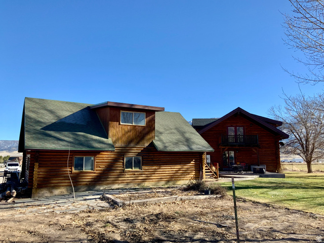76 Highway 118 Monroe, UT 84754 - Photo 75 of 76 Rear view of house featuring log exterior, a shingled roof, and a yard