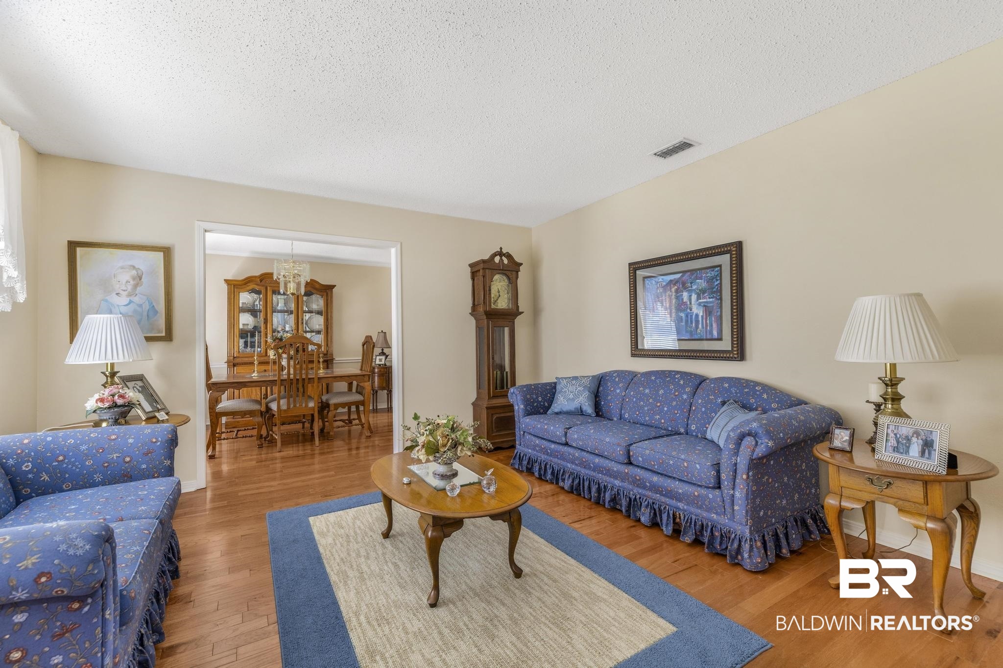 10207 Plantation Drive Daphne, AL 36526 - Photo 44 of 48 Living room featuring light wood finished floors, a textured ceiling, and suspended lighting