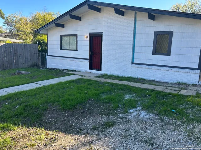 a view of backyard of house with green space