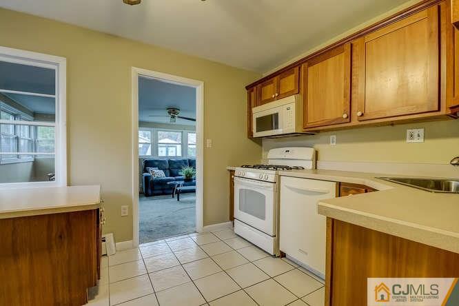 52 Sturgis Road Edison, NJ 08817 - Photo 16 of 22 a kitchen with stainless steel appliances granite countertop a stove a sink and a microwave