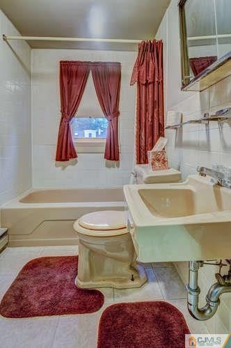 52 Sturgis Road Edison, NJ 08817 - Photo 19 of 22 a bathroom with a sink and a mirror