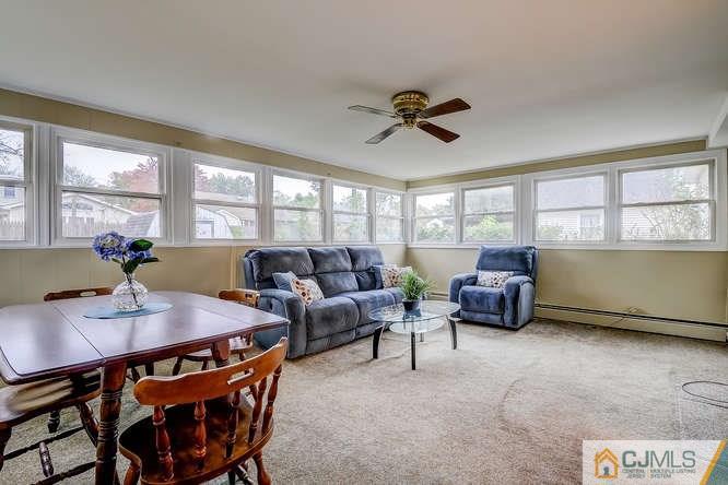 52 Sturgis Road Edison, NJ 08817 - Photo 7 of 22 a living room with furniture a large window and a potted plant