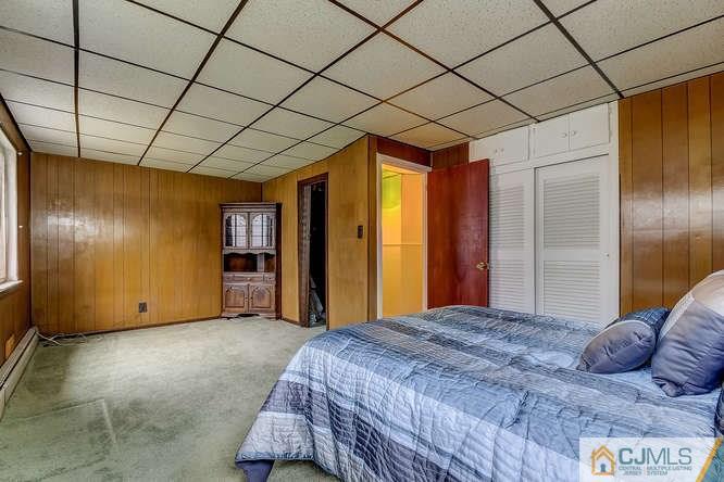 52 Sturgis Road Edison, NJ 08817 - Photo 10 of 22 a bedroom with a bed and a chandelier