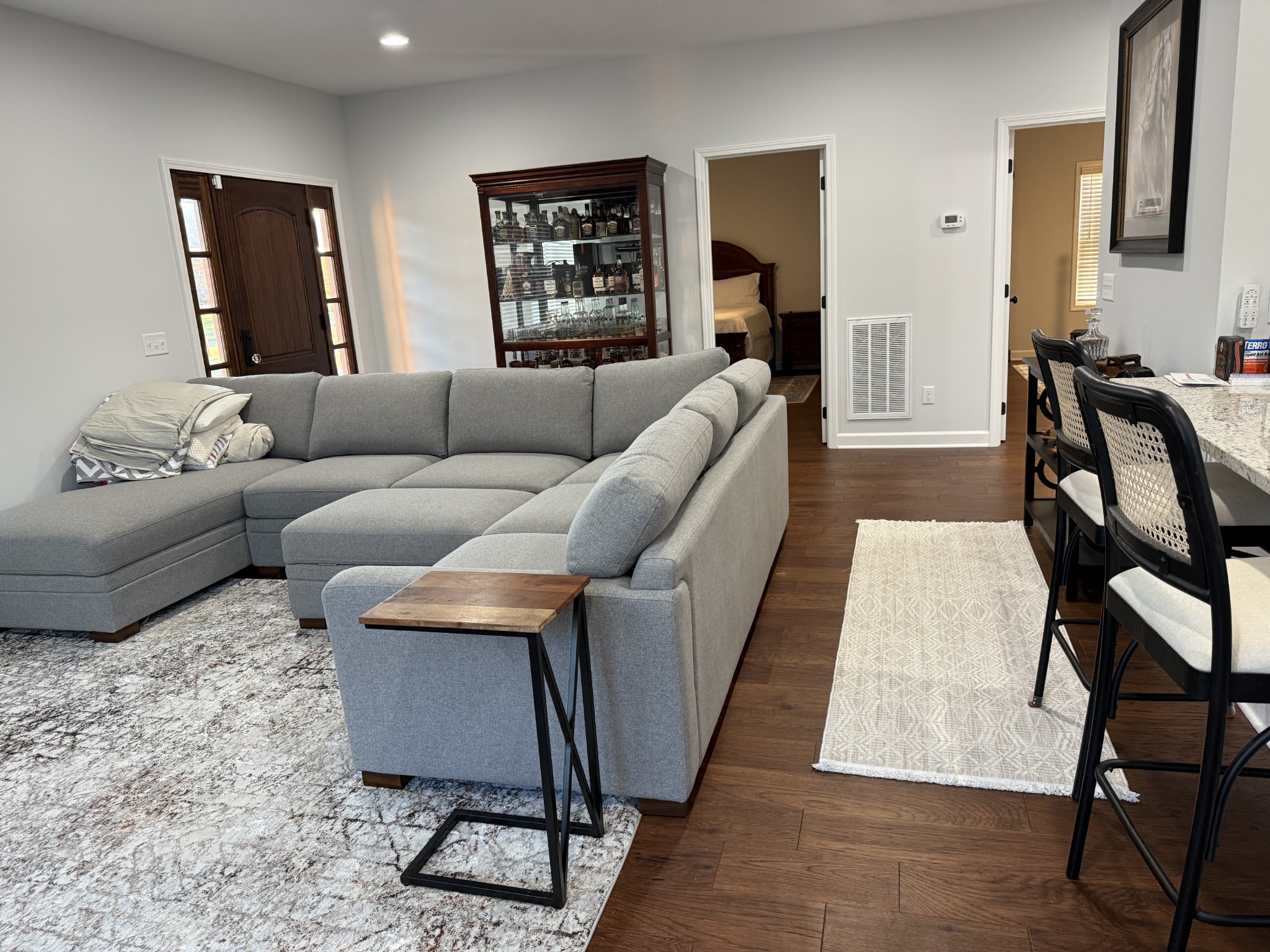 9461 Short Mountain Road Smithville, TN 37166 - Photo 11 of 26 a living room with furniture a wooden floor and a lamp