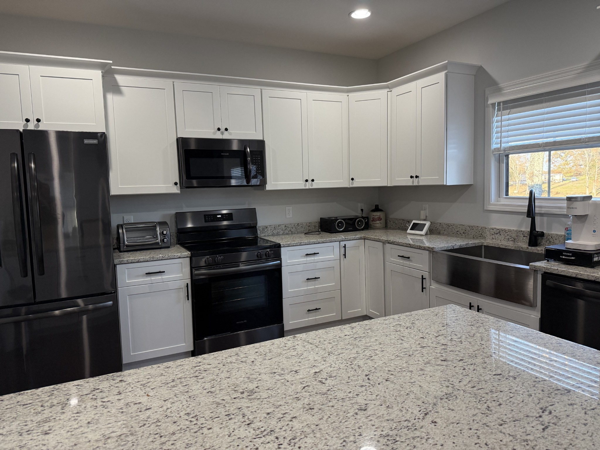 9461 Short Mountain Road Smithville, TN 37166 - Photo 12 of 26 a kitchen with a sink stove and refrigerator