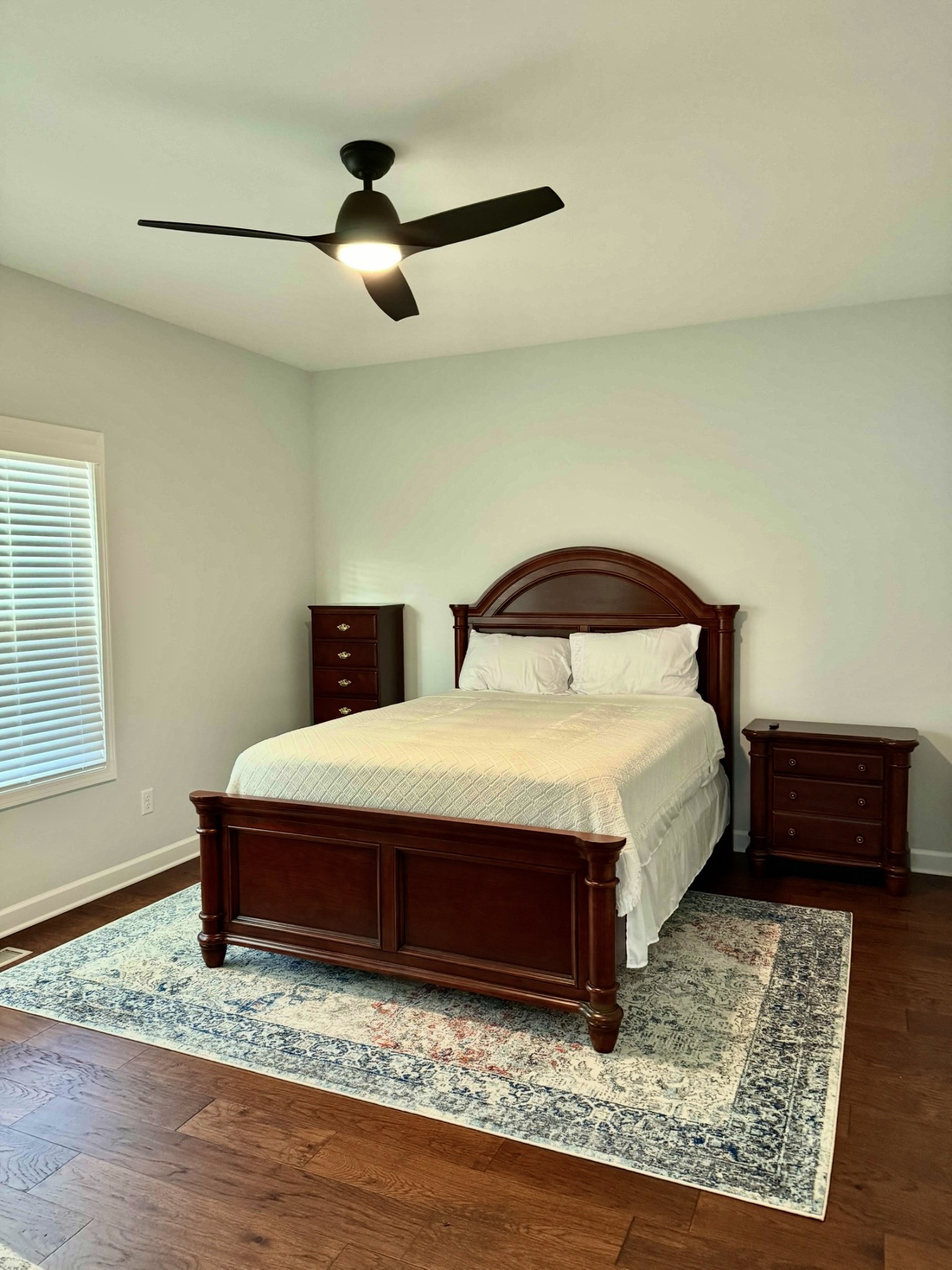 9461 Short Mountain Road Smithville, TN 37166 - Photo 9 of 26 a bedroom with a bed and wooden floor