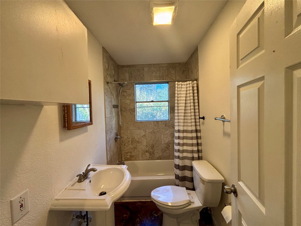 1606 Singleton Avenue Austin, TX 78702 - Photo 11 of 25 a bathroom with a sink a toilet a mirror and shower