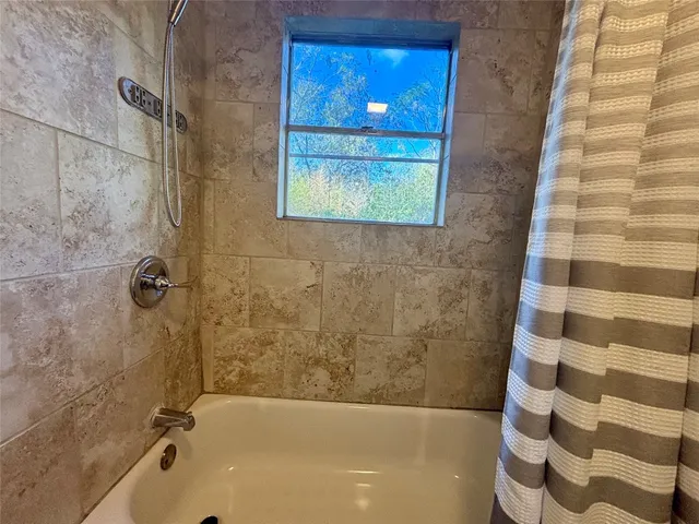 a bathroom with a bathtub and shower