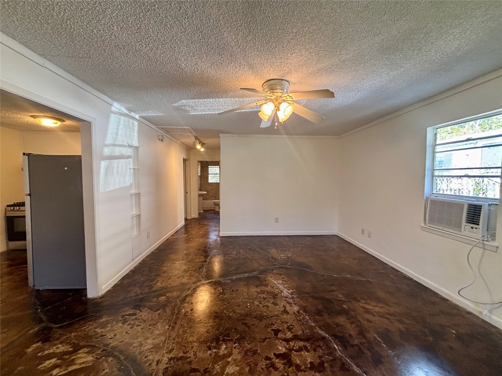 1606 Singleton Avenue Austin, TX 78702 - Photo 4 of 25 an empty room with wooden floor chandelier and windows
