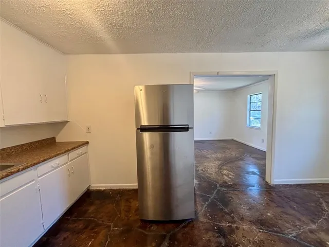 a walk in closet with wooden floor