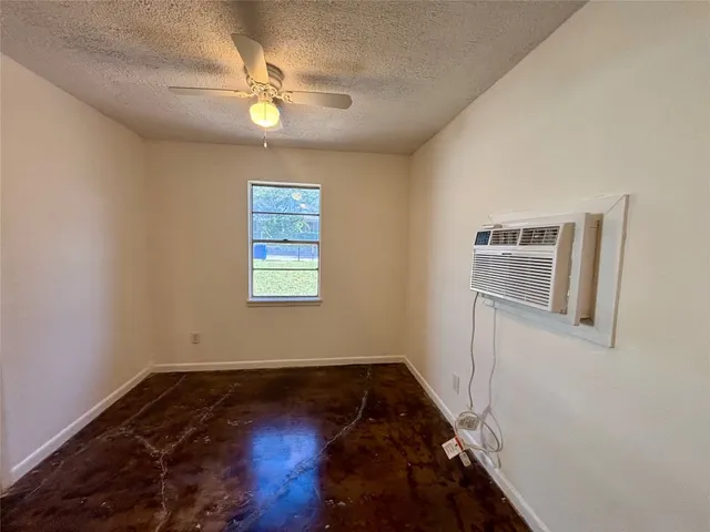a view of a livingroom with wooden floor and a ceiling fan
