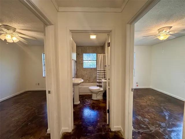 a view of a hallway with furniture and wooden floor