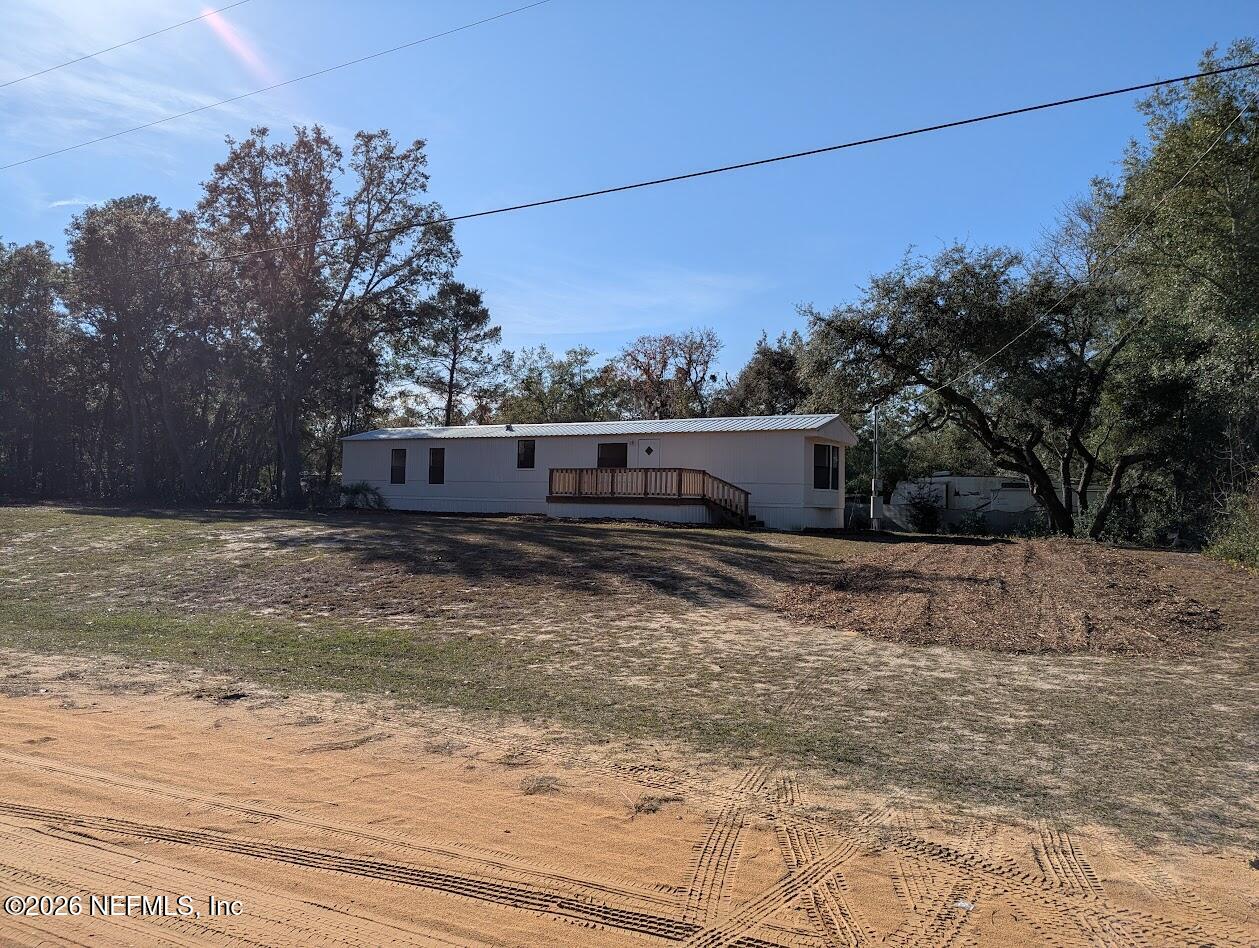 a view of a yard with wooden fence