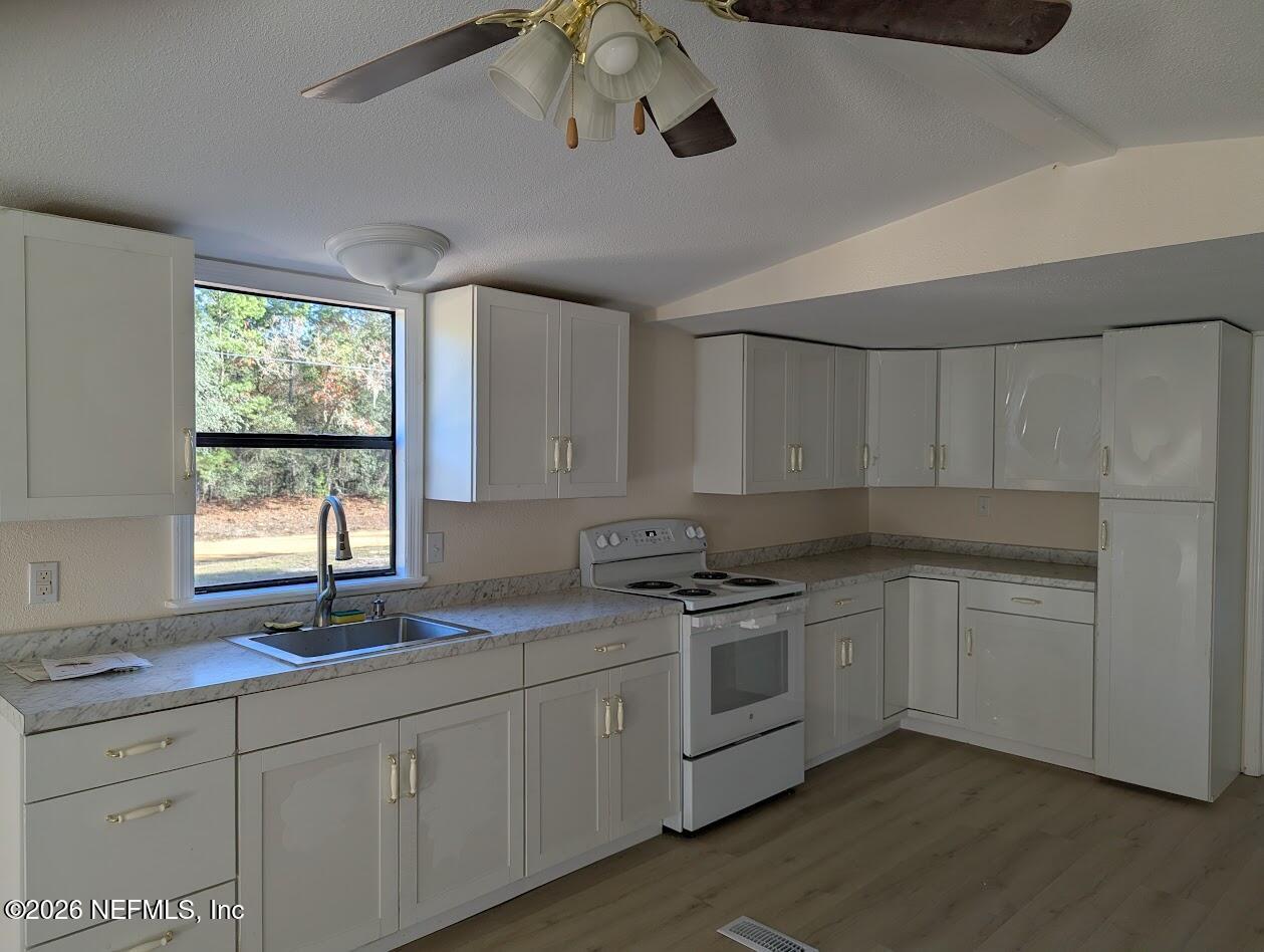119 Walter Avenue Interlachen, FL 32148 - Photo 7 of 21 a kitchen with a sink cabinets and window