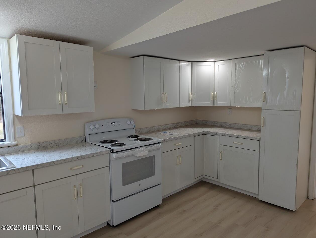 119 Walter Avenue Interlachen, FL 32148 - Photo 8 of 21 a kitchen with cabinets appliances and a sink
