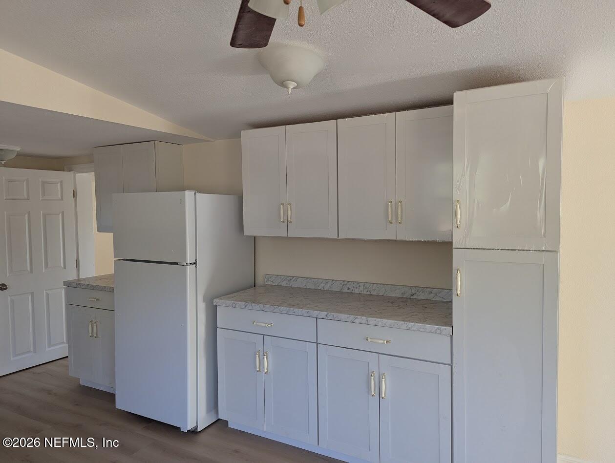 119 Walter Avenue Interlachen, FL 32148 - Photo 10 of 21 a white refrigerator freezer sitting inside of a kitchen
