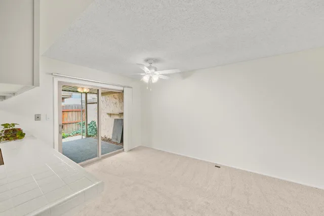 a view of a kitchen with wooden floor and electronic appliances