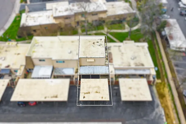 a view of a house with a yard and sitting area