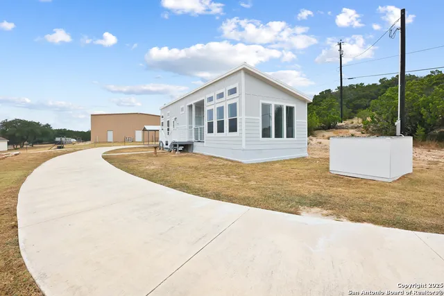 a view of a house with a backyard and kitchen