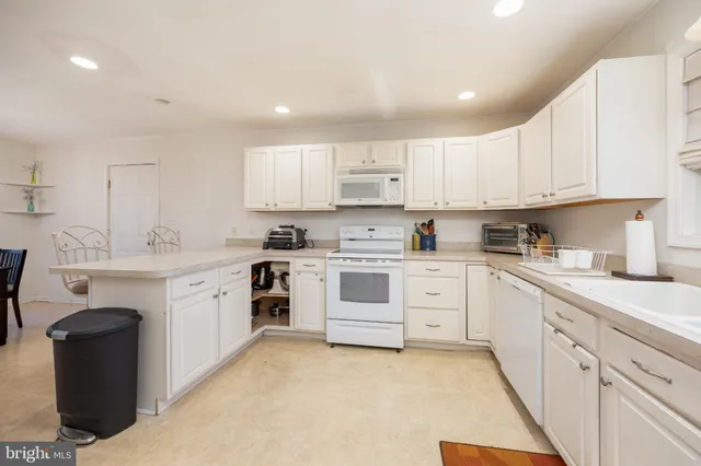 a kitchen with cabinets appliances a sink and a counter top space