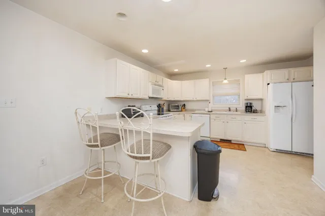 a kitchen with a refrigerator a sink and cabinets
