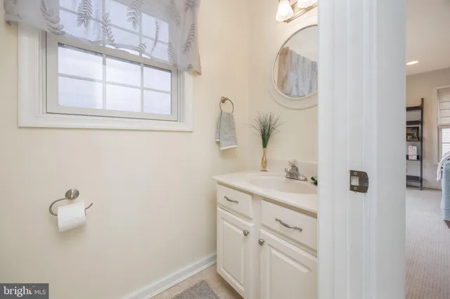 a bathroom with a sink a vanity and a mirror
