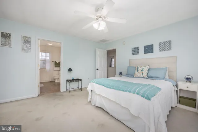 a spacious bedroom with a bed and a chandelier