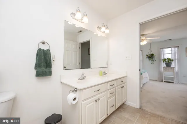 a spacious bathroom with a shower sink and mirror