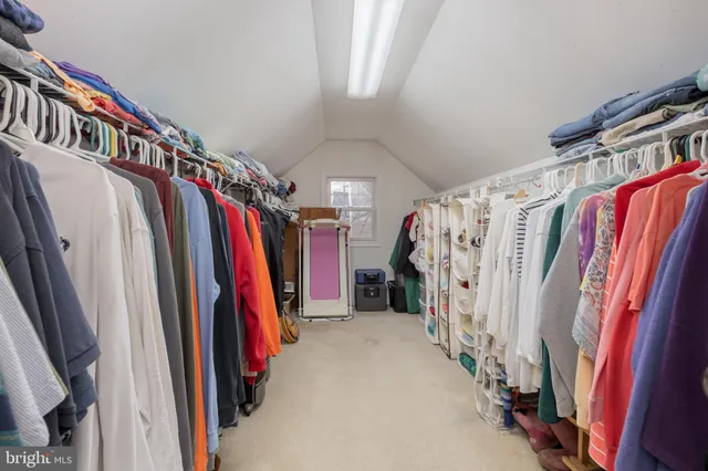 a view of walk in closet with clothes