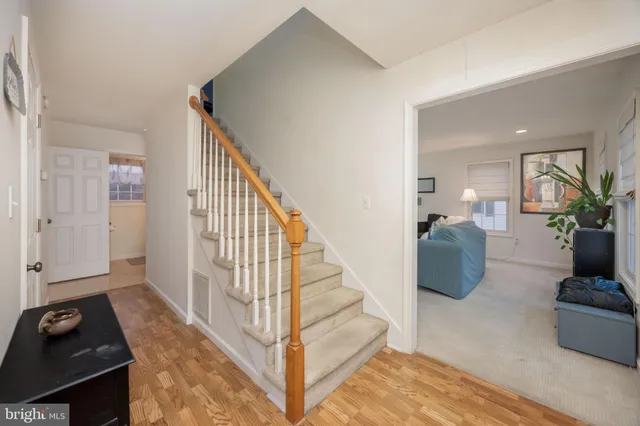 a view of a livingroom with wooden floor and furniture