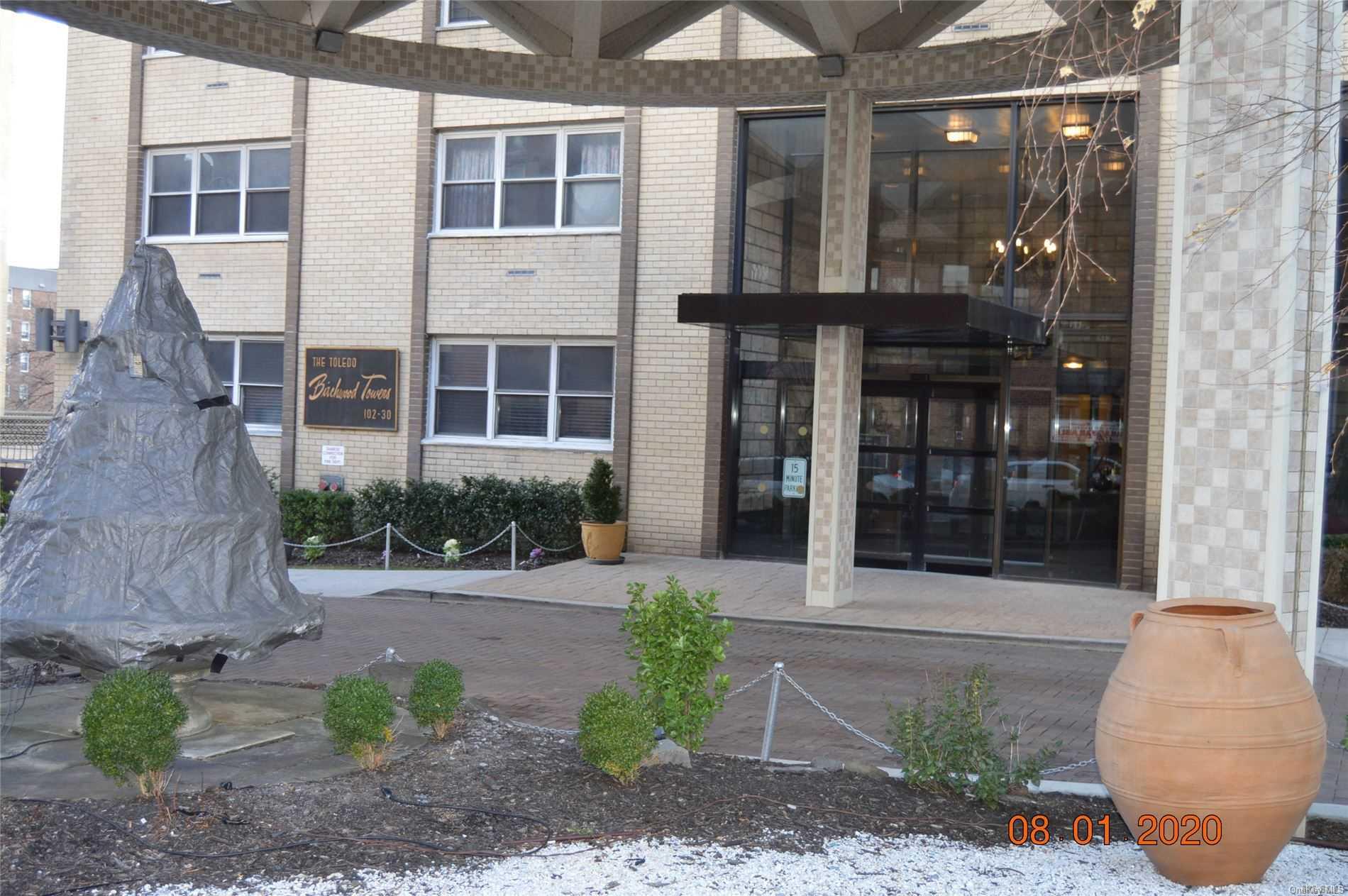 102-30 66th Road, Unit 25E Queens, NY 11375 - Photo 1 of 1 a front view of a house with a yard and potted plants