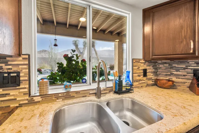 a kitchen with a sink and a large window