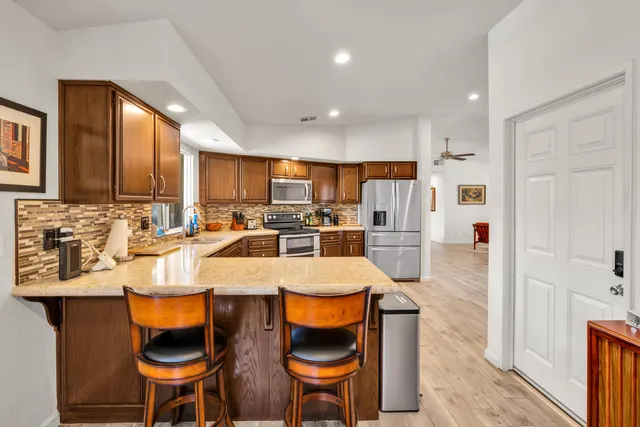 a large kitchen with lots of counter space and furniture