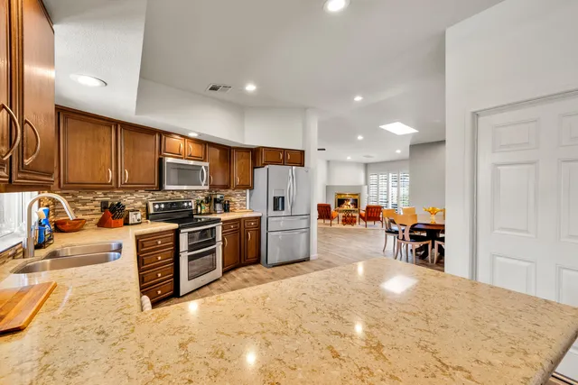 a kitchen with a refrigerator and a sink