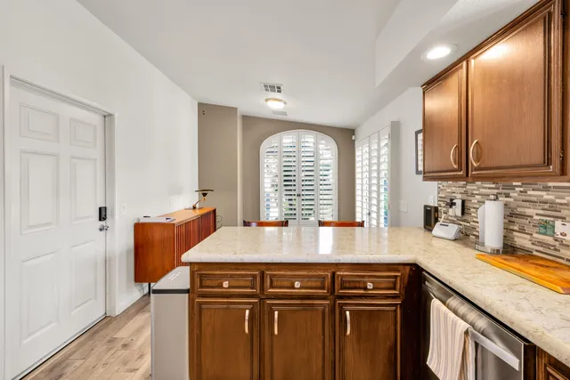 a kitchen with granite countertop a sink cabinets and window
